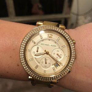 Women’s Michael Kors gold watch.